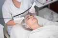 Macro close up portrait of woman having cosmetic galvanic beauty treatment in spa.