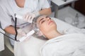 Macro close up portrait of woman having cosmetic galvanic beauty treatment in spa.Therapist applying low frequency Royalty Free Stock Photo