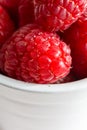 Macro close-up of red raspberries in white bowl Royalty Free Stock Photo