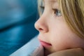 Macro close-up of sad child looking out of window Royalty Free Stock Photo