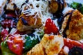 Macro close up of salad with fried turkey breast, tomatoes, green corn lettuce, fresh grated pecorino cheese and brown balsamic Royalty Free Stock Photo