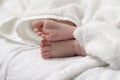 Macro Close-up Shot of a  Four Week Old Baby Boy Crossed Feet Over White Towel Royalty Free Stock Photo