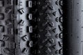 Macro close-up shot of tread of various black rubber bicycle tyres with different types of profile isolated white background Royalty Free Stock Photo