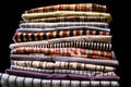 macro close-up of a stack of folded colorful mens button down shirts isolated on a black background Royalty Free Stock Photo