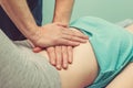 Macro close up of therapist applying pressure on stomach detail of hands massaging female belly