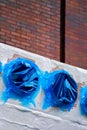 Blue Pipe covered vent outlets with blurry background brick wall