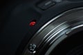 Macro closeup photo of lens to dslr camera on dark background view of red dot and silver extension ring and autofocus button Royalty Free Stock Photo