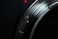 Macro closeup photo of lens to dslr camera on dark background view of red dot and silver extension ring and autofocus button Royalty Free Stock Photo