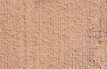 Macro closeup of plastered and painted peachy wall background Royalty Free Stock Photo