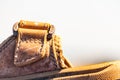 Macro closeup shot of a front part of a leather sandal with stitched seams around the perimeter of the fastener Royalty Free Stock Photo