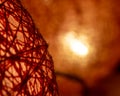 Macro closeup of thread ball lamp on blurred orange background Royalty Free Stock Photo