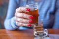 Macro closeup of woman holding a glass from beer flight Royalty Free Stock Photo