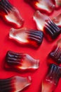 Red background with cola gummy bottles macro Royalty Free Stock Photo