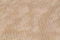 Macro color image of beige knitted texture.