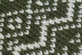 Macro color image of green and white knitted texture.