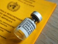 Macro of Comirnaty Biontech vaccination ampoule with a syringe and certificate against Covid-19 or Corona virus Royalty Free Stock Photo