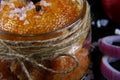 Macro delicious caviar, roe close up, pike caviar in a transparent jar, purple onion cut into rings on a black background, set