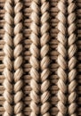 Macro Detail of Beige Knitted Wool Fabric Pattern with Textured Loops on Dark Backdrop Royalty Free Stock Photo