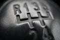 Macro detail of a black knob of a used manual shift gear (gear stick) in the aged vehicle Royalty Free Stock Photo