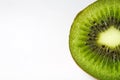 Macro detail closeup of one isolated half slice fresh ripe raw green kiwi fruit pulp and core, white blank background and copy Royalty Free Stock Photo