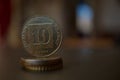 Macro detail of a metal Israeli coin & x28;10 Shekels, ten ILS& x29; on the top of column created of coins