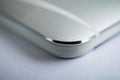 Macro detail of a silver brushed aluminum texture of sleek modern smart phone with shiny beveled edges