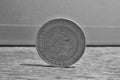 Macro detail of a silver and golden coin with head of queen in a value of two British Pounds 2 GBP on the wooden surface Royalty Free Stock Photo