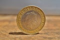 Macro detail of a silver and golden coin with head of queen in a value of two British Pounds 2 GBP on the wooden surface Royalty Free Stock Photo