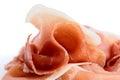 Macro detail of thinly sliced Prosciutto ham on white. Royalty Free Stock Photo