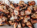 Macro of different kinds of meat cooked on metal skewers - juicy pork and chicken grilling on fire, coals and smoke in grill. Royalty Free Stock Photo