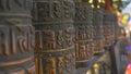 MACRO: Detailed view of ancient lettering written on the metal prayer wheels.