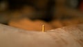 MACRO: Detailed view of a square wooden tack sitting inside hole in a shoe sole.