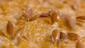 MACRO: Seeds are scattered across the crust of a loaf of whole-wheat bread. Royalty Free Stock Photo