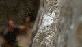 MACRO: Magnesium particles fly around a crimp hold after climber slips and falls Royalty Free Stock Photo