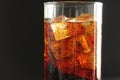 Macro drink kvass Coca-Cola with ice close-up bubbles in drink soda on a dark black background Royalty Free Stock Photo