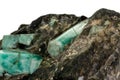 Macro emerald stone mineral in rock on white background