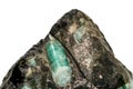 Macro emerald stone mineral in rock on white background