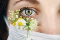 Young attractive woman in floral face mask