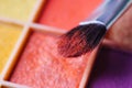 Macro. Eyeshadows of red color on the bristles of the brush in the form of individual crystals. Royalty Free Stock Photo