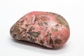 Macro focused tumbled and polished pink rhodonite crystal