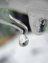 A Macro Frozen Water Drop on a Pipe in Winter