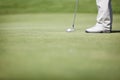 Macro of golf player putting. Royalty Free Stock Photo