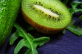 Macro green assortment vegetables and fruits, avocados, kiwi, rucola salad on a shale board, the concept of healthy eating, close-