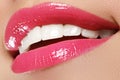 Macro happy woman's smile with healthy white teeth, bright pink Royalty Free Stock Photo