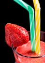 Macro healthy strawberry smoothie in glass with colored drink st