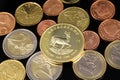 A close up image of Euro coins with a gold South African coin on a black background Royalty Free Stock Photo