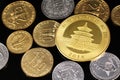 A close up image of West African Franc coins and a gold Chinese one ounce coin on a black background Royalty Free Stock Photo