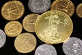 A close up image of West African Franc coins and a gold Chinese one ounce coin on a black background Royalty Free Stock Photo