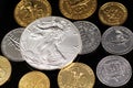 A close up image of West African Franc coins and a silver American one ounce coin on a black background Royalty Free Stock Photo