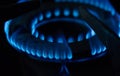 A Macro Image of a Blurry Blue Flames on Gas Stove Burner Royalty Free Stock Photo